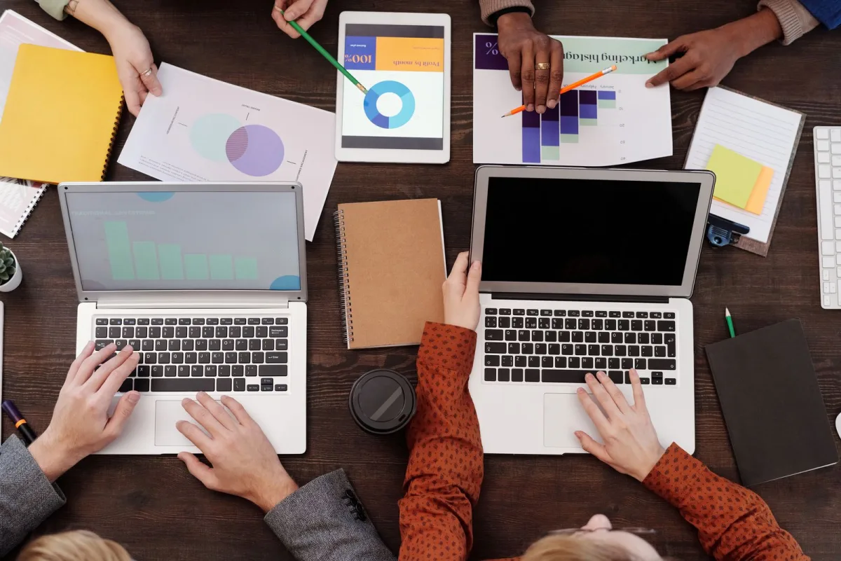 Startup team reviewing charts and reports around a table