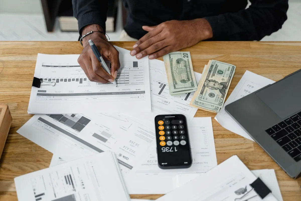 Accountant's workspace with calculator, documents and laptop