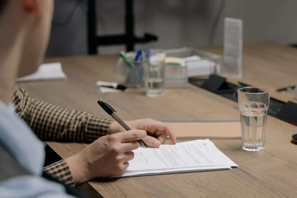 Close-up of a client signing a consulting contract