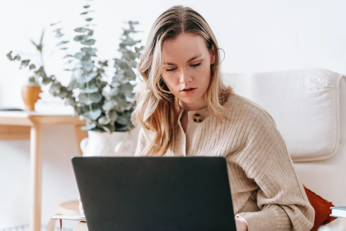 Freelancer working on a laptop at a home desk