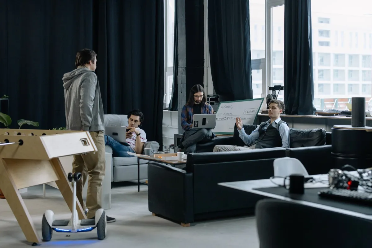 Startup team in an open office with an oversized prize cheque on the wall