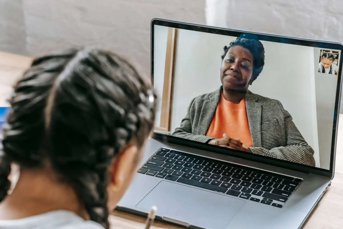 Woman following an online lesson with an instructor on her laptop