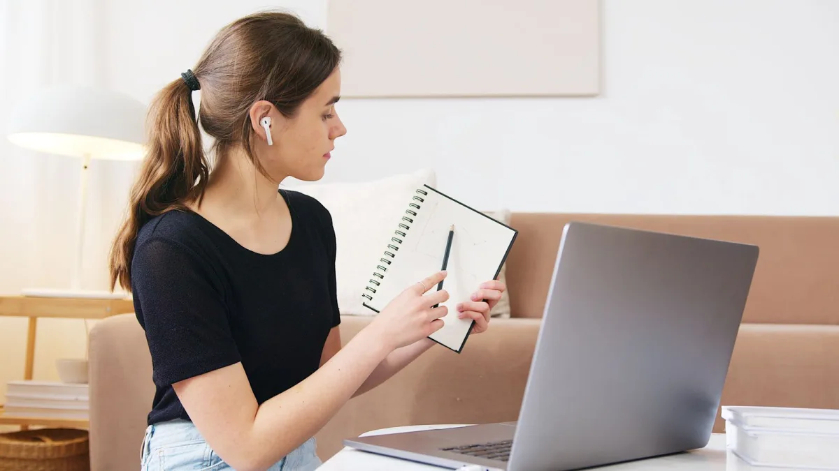 Focused woman attending an online webinar on her laptop