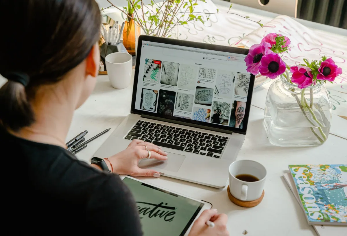 Beginner freelancer collecting design inspiration on a laptop and tablet