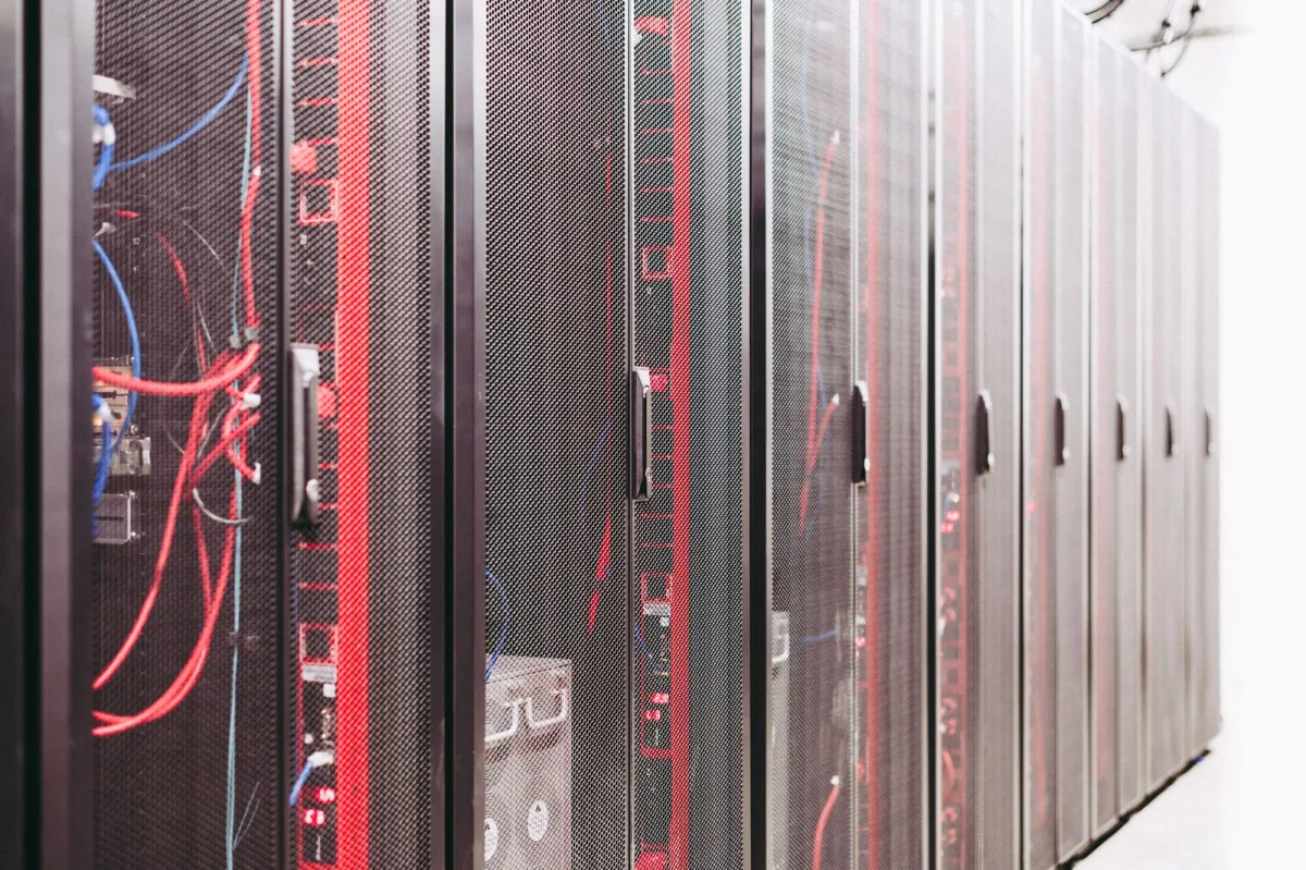 Rows of server racks with network cabling in a modern data center