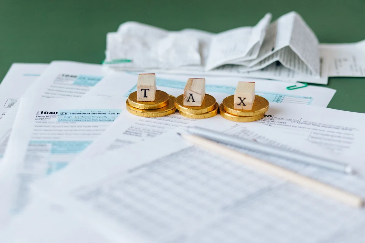 US tax forms with a calculator and coins on a table