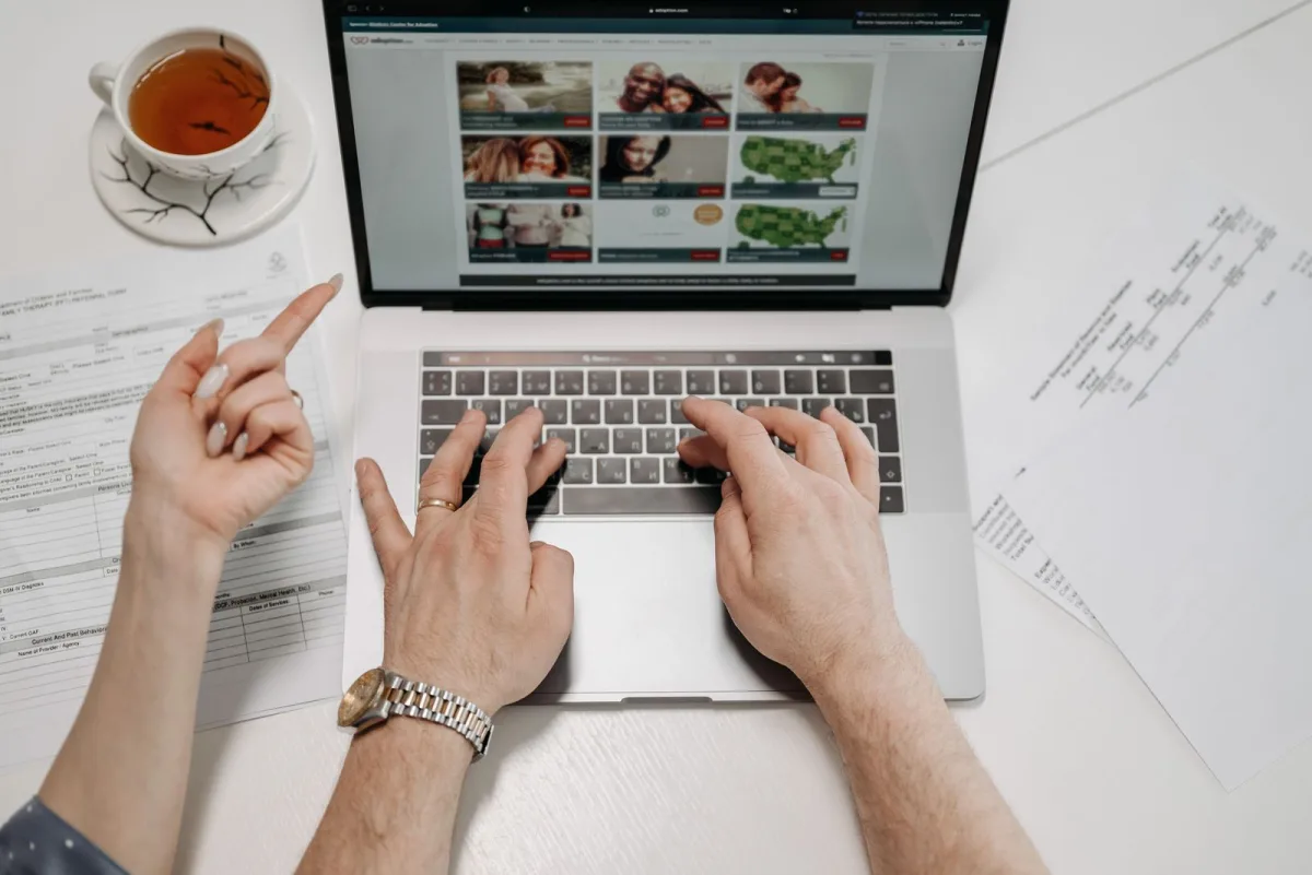 Person typing an email newsletter on a laptop