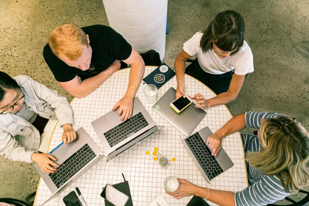Team working together on laptops seen from above